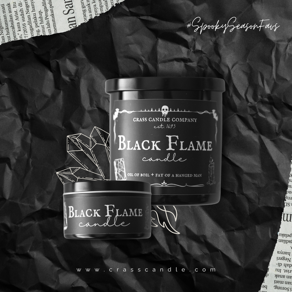 Two black flame candles sit in front of a black background. One candle is a black jar with a lid and the other is a black round tin. Both labels are black with white lettering that say "Black Flame Candle".