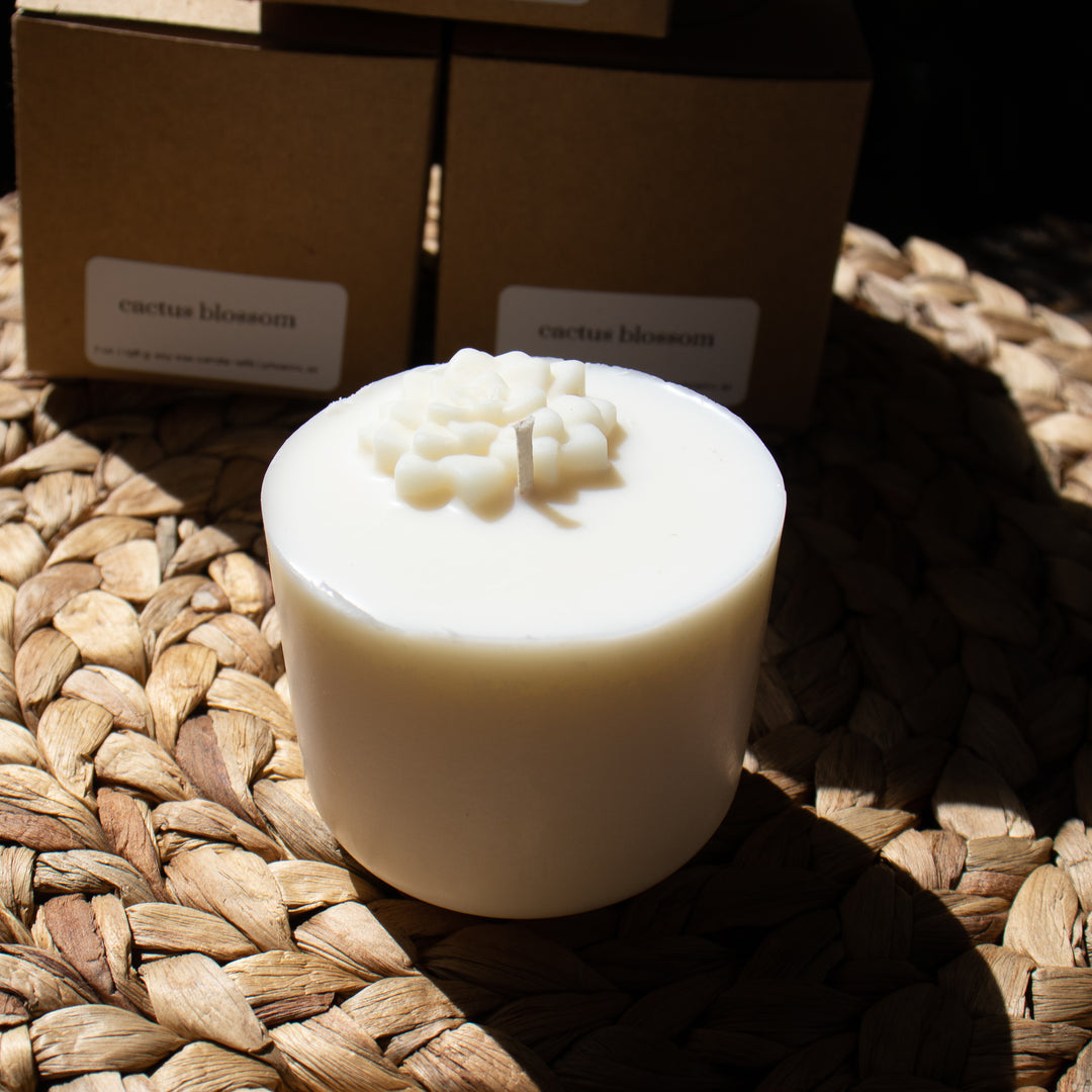 A white soy wax candle refill in front of the box it comes in.
