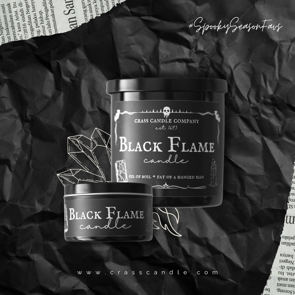 Two black flame candles sit in front of a black background. One candle is a black jar with a lid and the other is a black round tin. Both labels are black with white lettering that say "Black Flame Candle". 