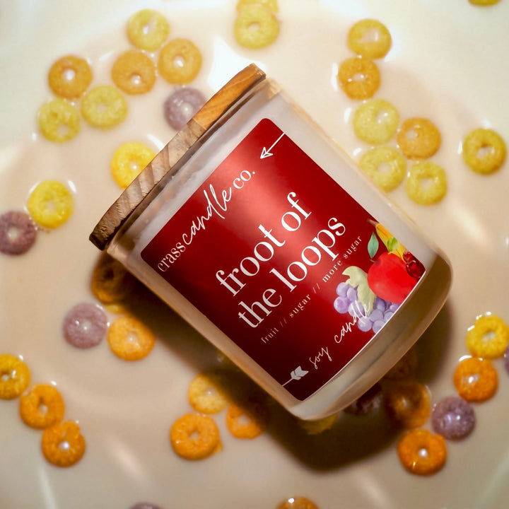 Candle labeled 'Froot of the Loops' on a plate with cereal pieces